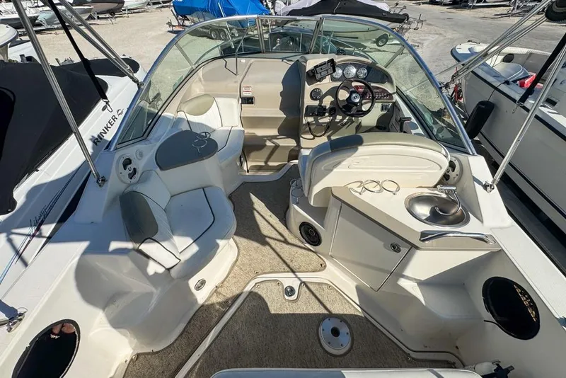 Slide: The Image of 2007 Sea Ray 240 Sundancer boat interior with seating, steering wheel, and sink. - 21