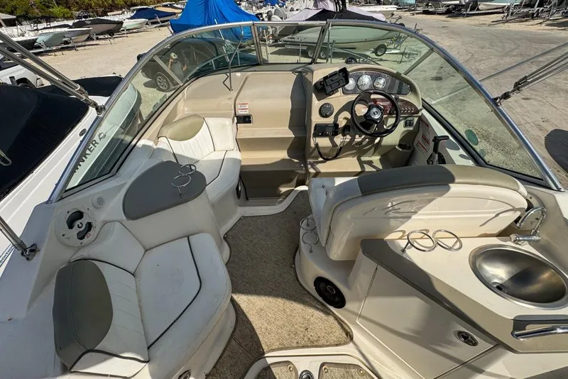 Slide: The Image of 2007 Sea Ray 240 Sundancer boat interior with steering wheel and seating area. - 24