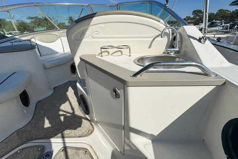 Slide: The Image of 2007 Sea Ray 240 Sundancer boat interior with sink and seating area. - 27