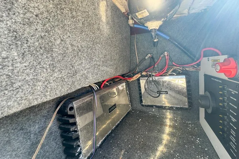 Slide: The Image of Electrical components inside a 2007 Sea Ray 240 Sundancer boat, featuring wiring and control panel. - 30