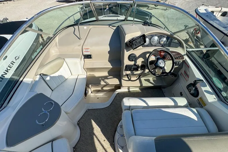 Slide: The Image of 2007 Sea Ray 240 Sundancer boat interior with steering wheel and seating area. - 32