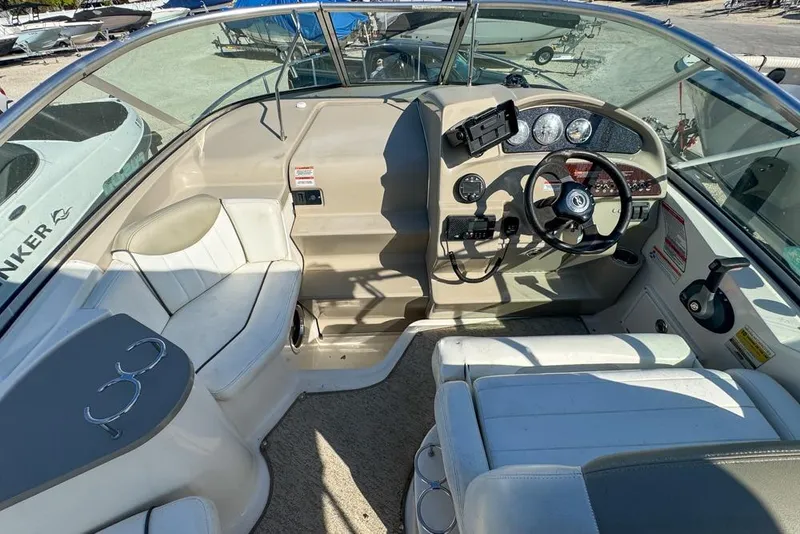 Slide: The Image of 2007 Sea Ray 240 Sundancer boat interior with steering wheel and seating area. - 33