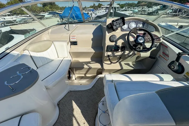 Slide: The Image of 2007 Sea Ray 240 Sundancer boat interior with steering wheel and seating area. - 34