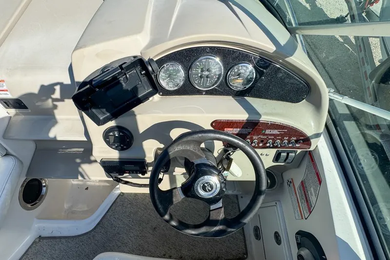 Slide: The Image of 2007 Sea Ray 240 Sundancer boat dashboard with steering wheel and instrument panel. - 35
