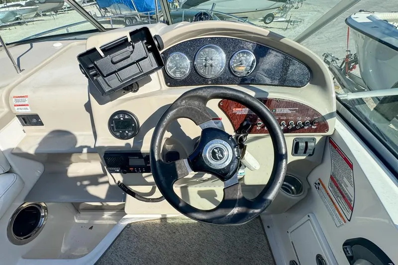 Slide: The Image of Steering console of a 2007 Sea Ray 240 Sundancer boat with gauges and controls. - 36