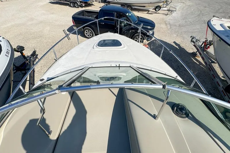 Slide: The Image of 2007 Sea Ray 240 Sundancer boat, top view, parked near vehicles and trailers. - 44