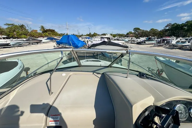 Slide: The Image of 2007 Sea Ray 240 Sundancer boat in a marina with other vessels. - 47