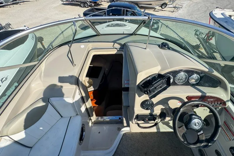 Slide: The Image of 2007 Sea Ray 240 Sundancer boat cockpit with steering wheel and cabin entrance. - 50