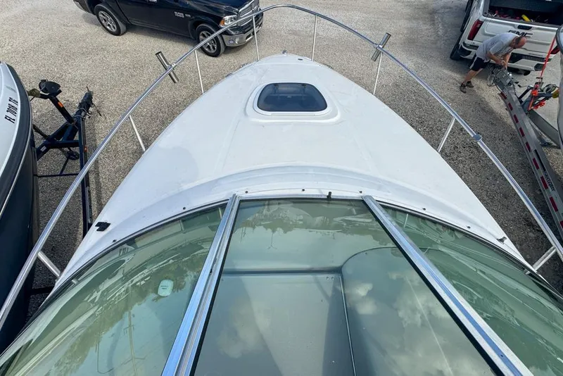 Slide: The Image of 2007 Sea Ray 240 Sundancer boat, top view, parked with vehicles nearby. - 54