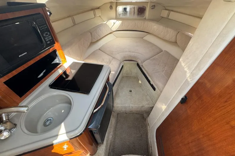 Slide: The Image of 2007 Sea Ray 240 Sundancer cabin interior with kitchenette and seating area. - 57