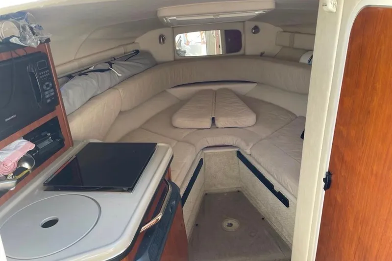 Slide: The Image of 2007 Sea Ray 240 Sundancer cabin interior with cozy seating and kitchenette. - 59