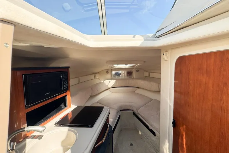 Slide: The Image of Interior of 2007 Sea Ray 240 Sundancer with cozy seating and kitchenette. - 61