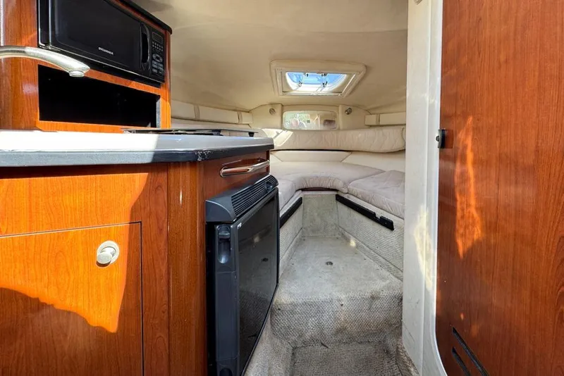 Slide: The Image of 2007 Sea Ray 240 Sundancer cabin interior with kitchenette and seating area. - 62