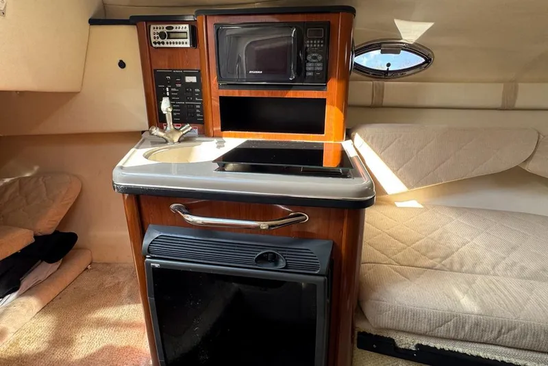 Slide: The Image of 2007 Sea Ray 240 Sundancer cabin with kitchenette, microwave, and seating area. - 71