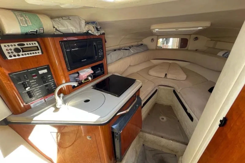 Slide: The Image of 2007 Sea Ray 240 Sundancer boat on trailer, black and white exterior, sunny day. - 8