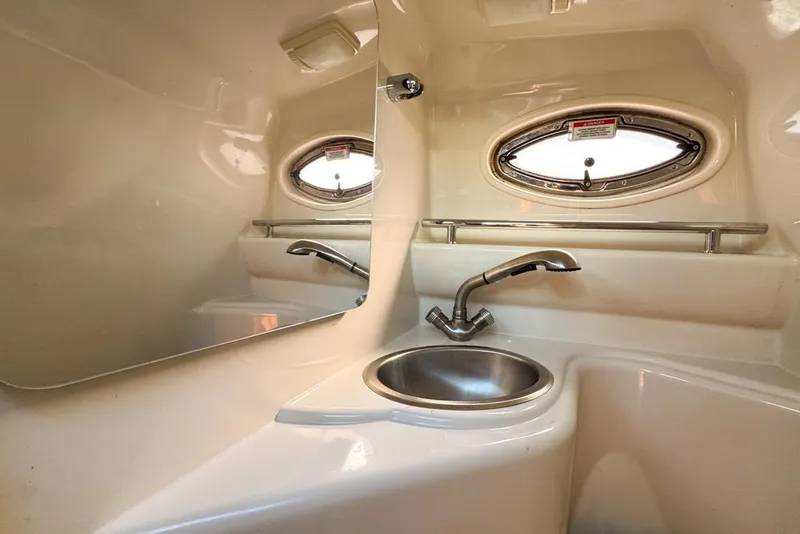 Slide: The Image of 2007 Sea Ray 240 Sundancer bathroom with sink and oval window. - 80