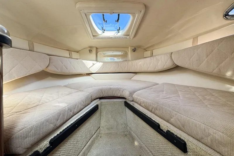 Slide: The Image of Interior cabin of 2007 Sea Ray 240 Sundancer with beige upholstery and skylight. - 83
