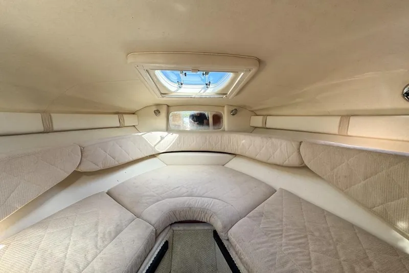Slide: The Image of Interior cabin of 2007 Sea Ray 240 Sundancer with beige upholstery and overhead hatch. - 85