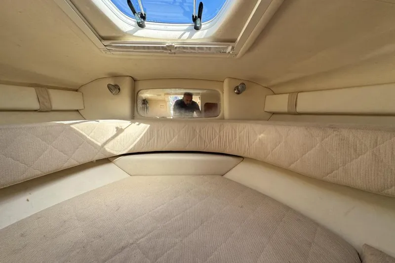 Slide: The Image of Interior cabin of 2007 Sea Ray 240 Sundancer with beige upholstery and overhead hatch. - 88
