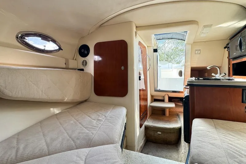 Slide: The Image of Interior of 2007 Sea Ray 240 Sundancer boat with cozy seating and kitchenette. - 93