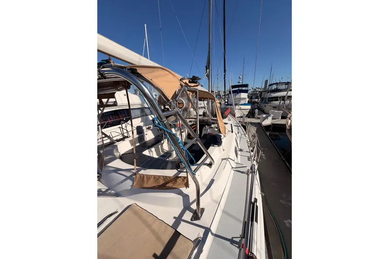 Slide: The Image of 2005 Hunter Passage 456 sailboat docked at marina under clear blue sky. - 11