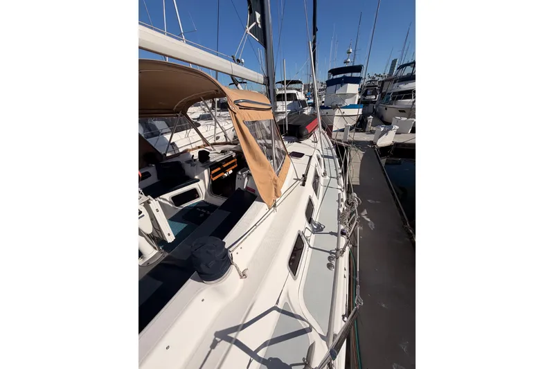 Slide: The Image of 2005 Hunter Passage 456 sailboat docked at marina, showcasing deck and cockpit area. - 13