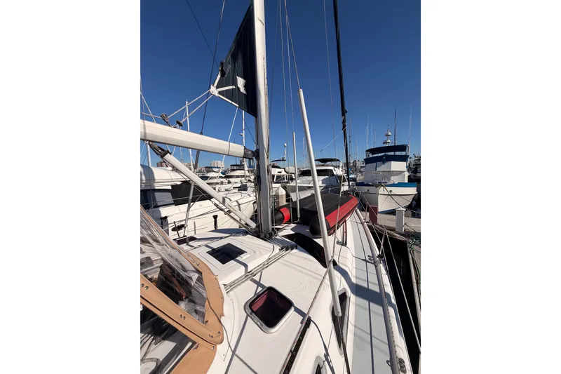 Slide: The Image of 2005 Hunter Passage 456 sailboat docked in a marina under clear blue skies. - 14