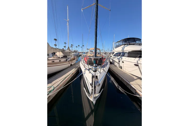 Slide: The Image of 2005 Hunter Passage 456 sailboat docked in a marina, surrounded by other boats. - 2