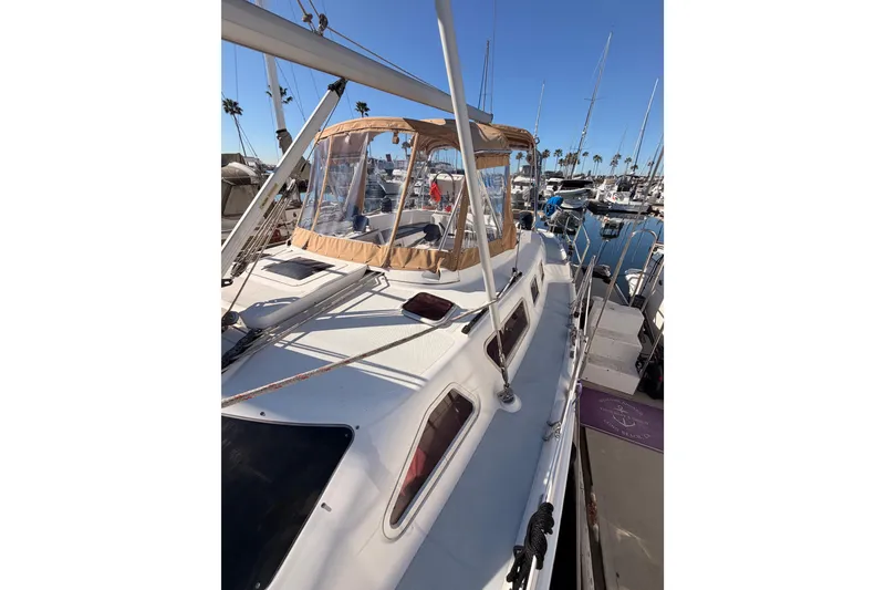 Slide: The Image of 2005 Hunter Passage 456 sailboat docked in a marina under clear blue skies. - 21