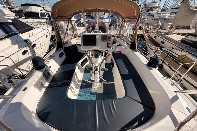 Slide: The Image of Cockpit of 2005 Hunter Passage 456 sailboat, featuring navigation equipment and seating. - 26