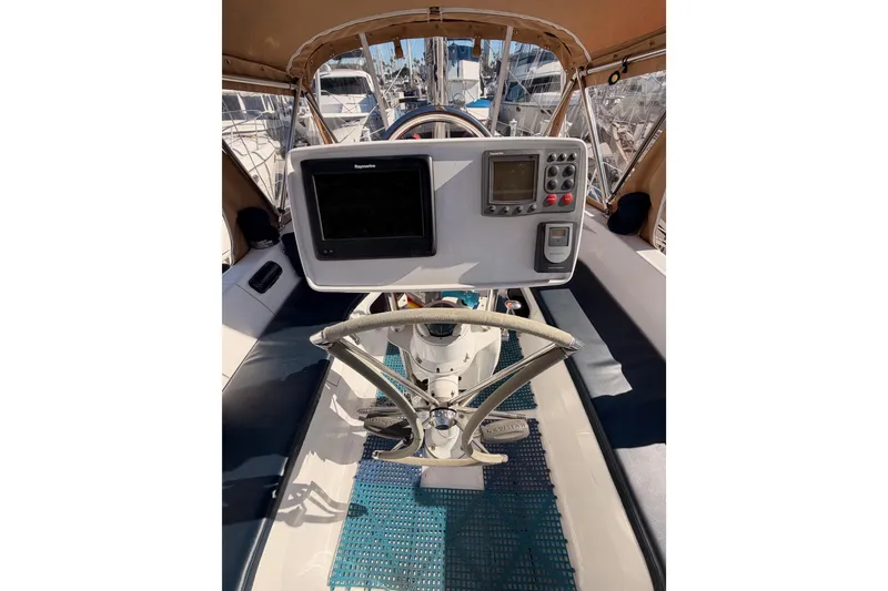 Slide: The Image of Cockpit of 2005 Hunter Passage 456 sailboat with navigation equipment and steering wheel. - 27