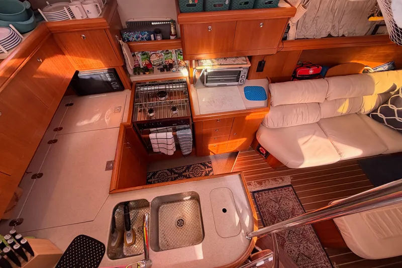 Slide: The Image of Interior of 2005 Hunter Passage 456 yacht with kitchen and seating area. - 34