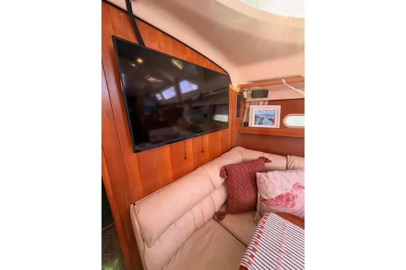 Slide: The Image of Interior of 2005 Hunter Passage 456 yacht with TV and cozy seating area. - 52