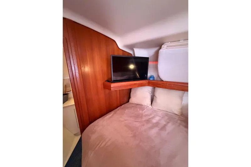 Slide: The Image of Cozy cabin interior of 2005 Hunter Passage 456 yacht with TV and wooden paneling. - 56