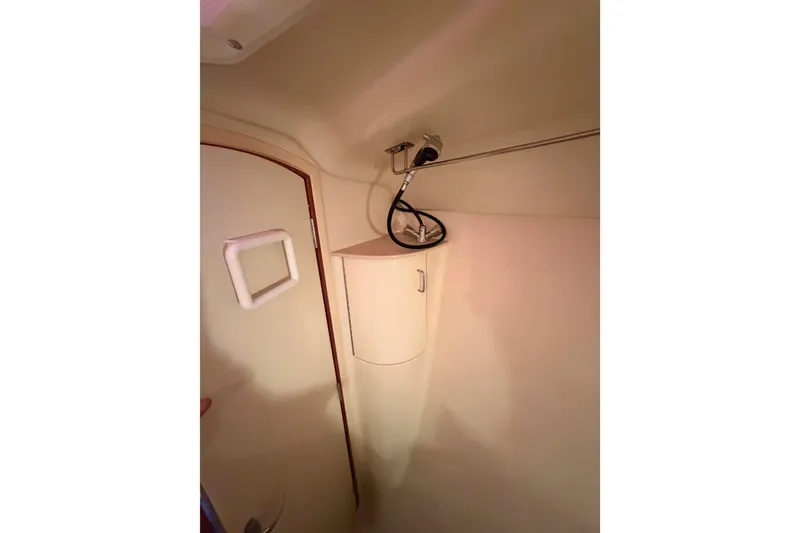 Slide: The Image of Interior of 2005 Hunter Passage 456 yacht bathroom with shower and storage cabinet. - 59