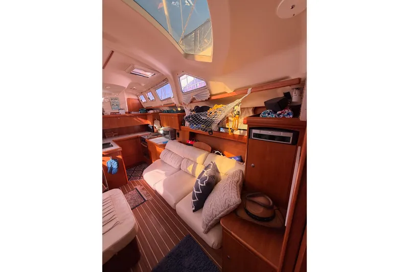 Slide: The Image of Interior of 2005 Hunter Passage 456 yacht with cozy seating and wooden cabinetry. - 64