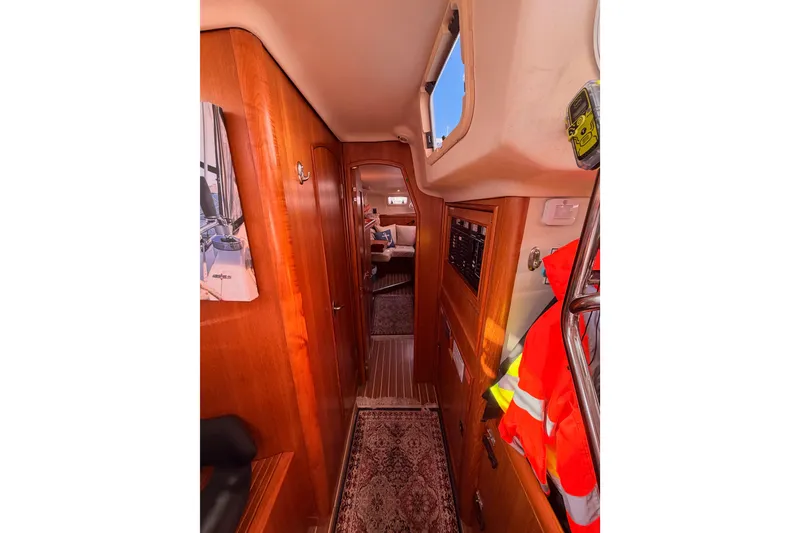 Slide: The Image of Interior of 2005 Hunter Passage 456 yacht with wooden paneling and nautical decor. - 66