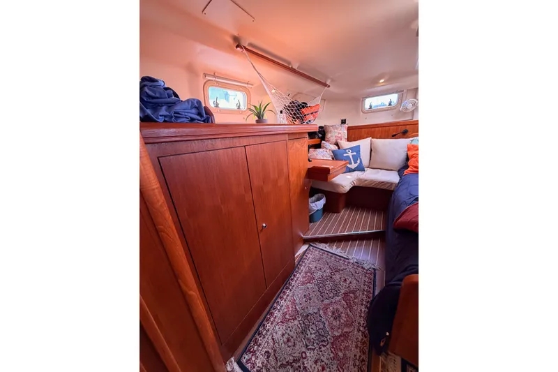 Slide: The Image of Cozy interior of 2005 Hunter Passage 456 sailboat with wooden cabinetry and nautical decor. - 69