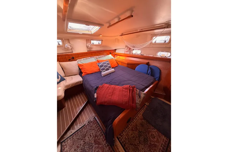 Slide: The Image of Cozy cabin interior of 2005 Hunter Passage 456 yacht with bed and seating area. - 70