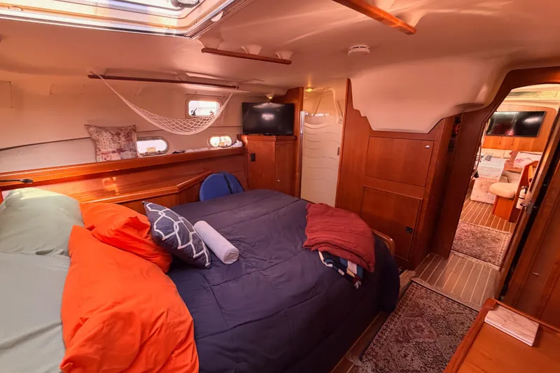 Slide: The Image of Luxurious 2005 Hunter Passage 456 yacht interior with cozy bedroom and elegant wood finishes. - 73