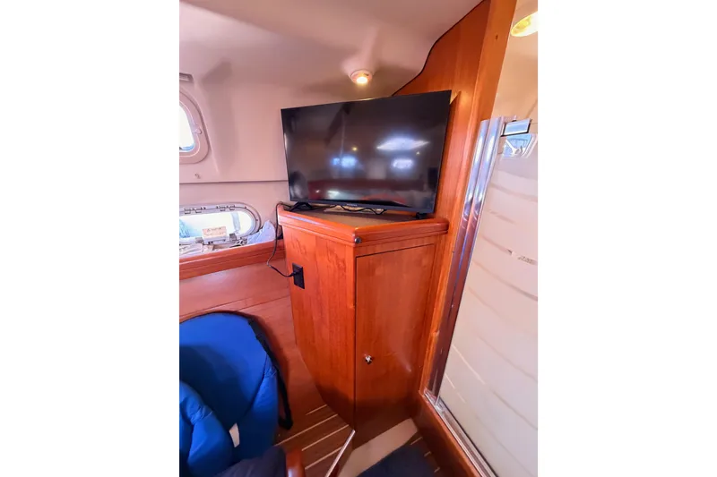 Slide: The Image of Interior of 2005 Hunter Passage 456 yacht with TV and wooden cabinetry. - 74