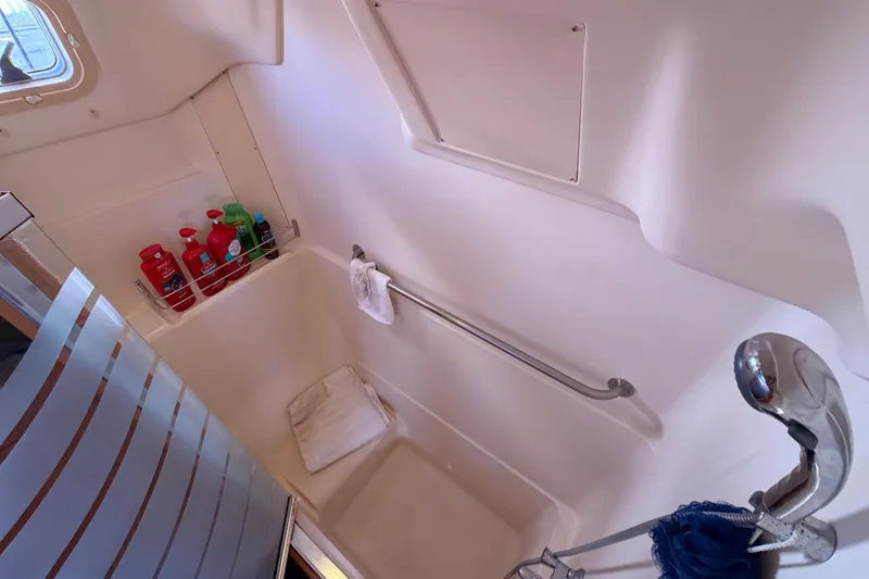 Slide: The Image of Interior of 2005 Hunter Passage 456 yacht bathroom with shower and toiletries. - 76