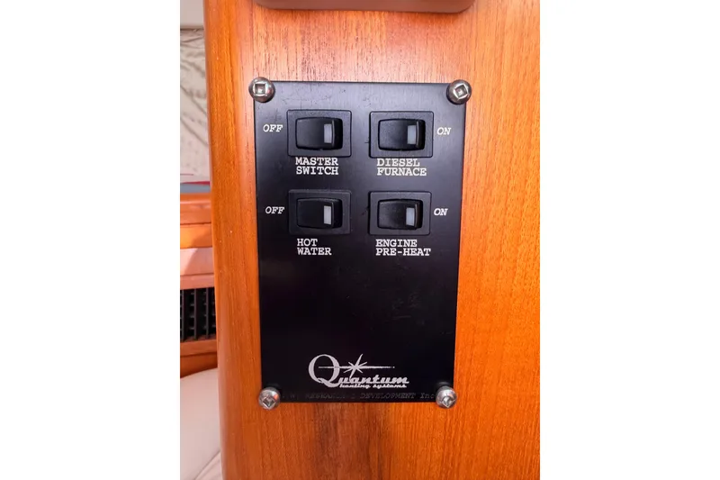 Slide: The Image of Control panel on a 2005 Hunter Passage 456 yacht with switches for various functions. - 83