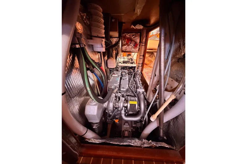 Slide: The Image of Engine compartment of 2005 Hunter Passage 456 sailboat, showcasing detailed mechanical components. - 85