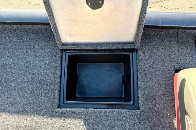 Slide: The Image of Open storage compartment in 2017 Ranger RT198P boat, featuring carpeted interior. - 10