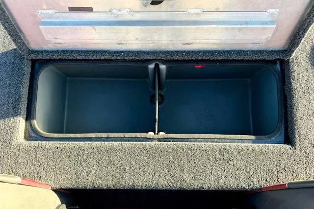 Slide: The Image of 2017 Ranger RT198P boat storage compartment with open lid, showing spacious interior. - 11