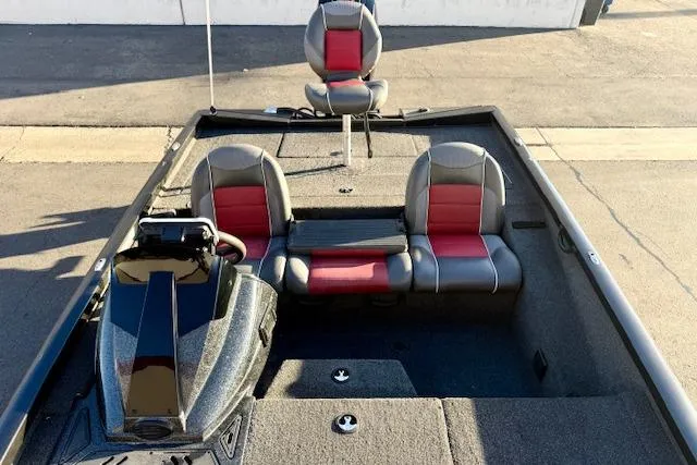 Slide: The Image of 2017 Ranger RT198P boat interior with red and gray seating, steering console, and carpeted deck. - 15