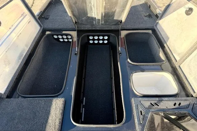 Slide: The Image of 2017 Ranger RT198P boat storage compartments with open lids, showcasing organized interior space. - 21
