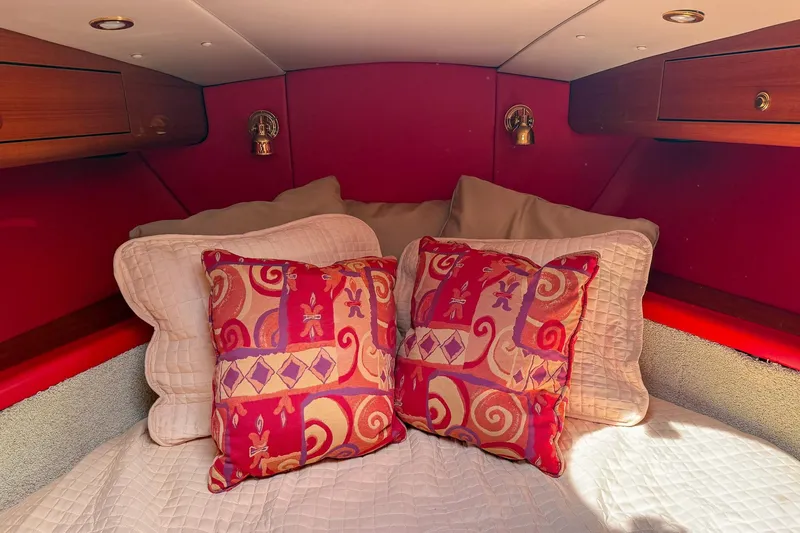 Slide: The Image of Luxurious cabin interior of 2002 Hallett Express Cruiser with vibrant pillows and wood accents. - 10