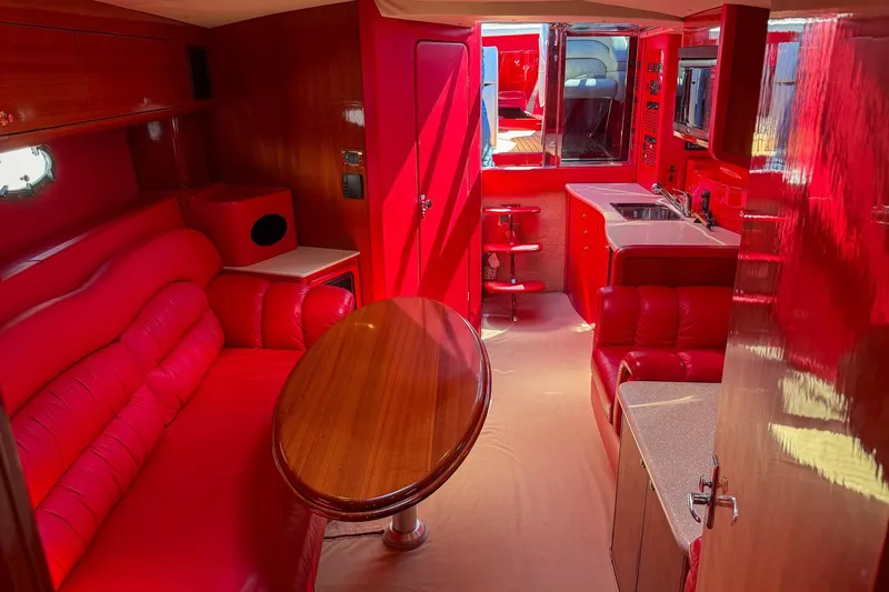 Slide: The Image of Luxurious red interior of a 2002 Hallett Custom High Performance Express Cruiser. - 12